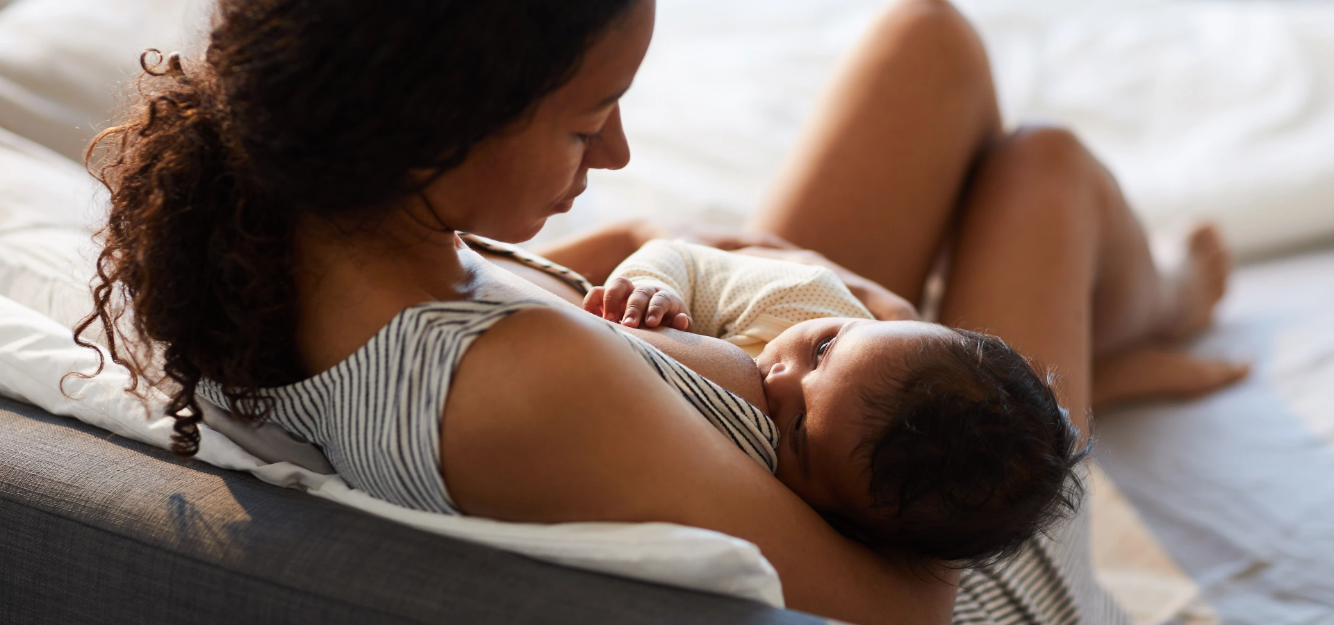 A young mother breastfeeding her baby.