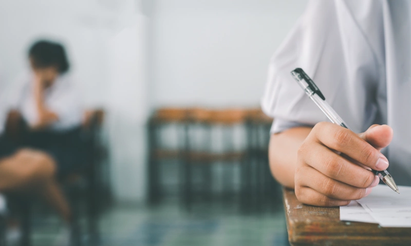 Young people taking an academic test.