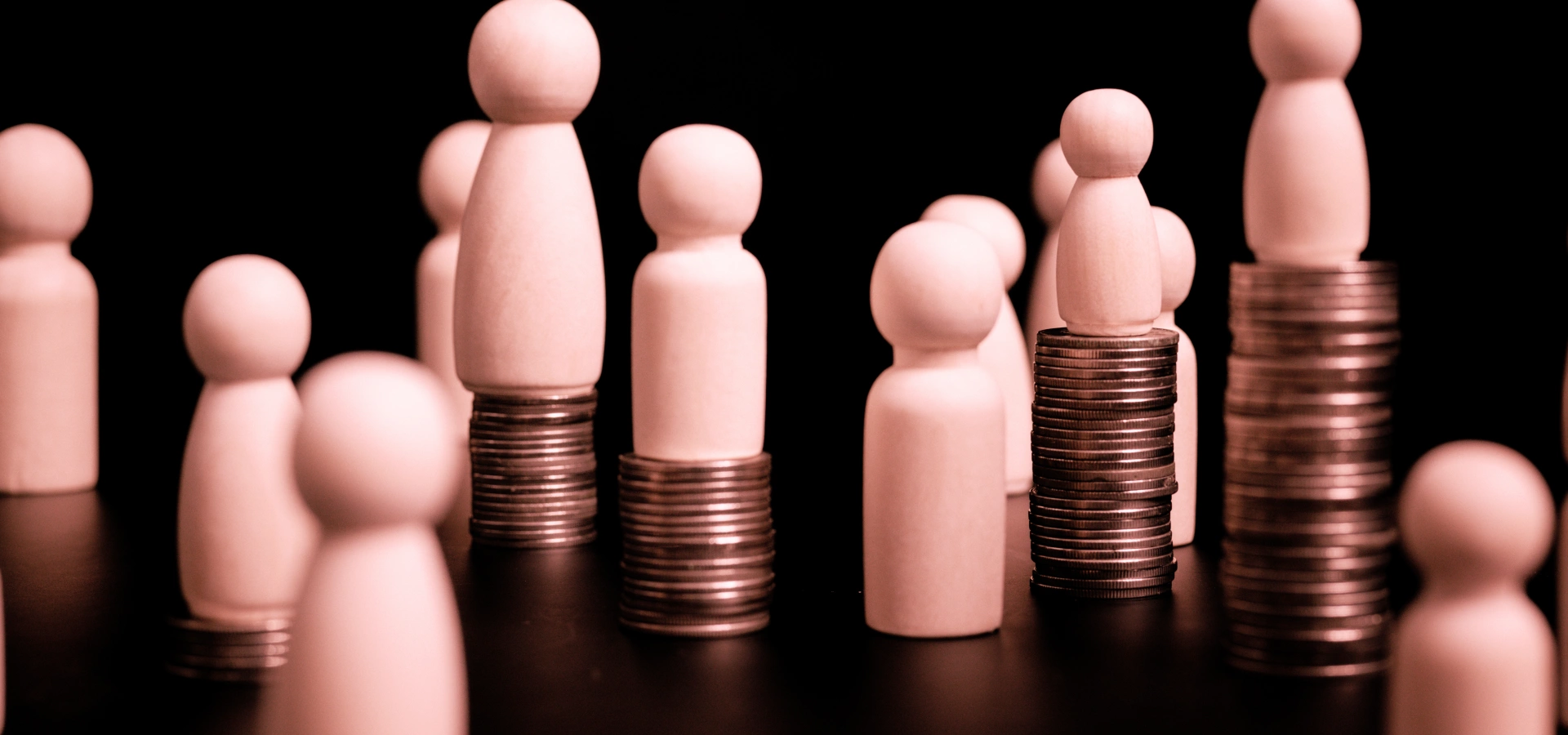 Wooden pegs on piles of coins of different height.