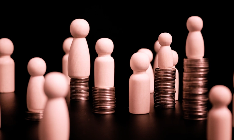 Wooden pegs on piles of coins of different height.