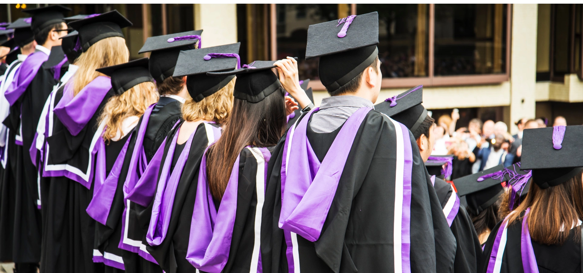 Group of university student in their graduation robes and caps.