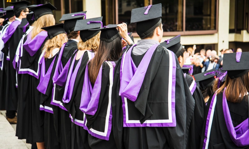 Group of university student in their graduation robes and caps.