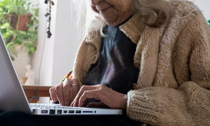 Old woman using a laptop.