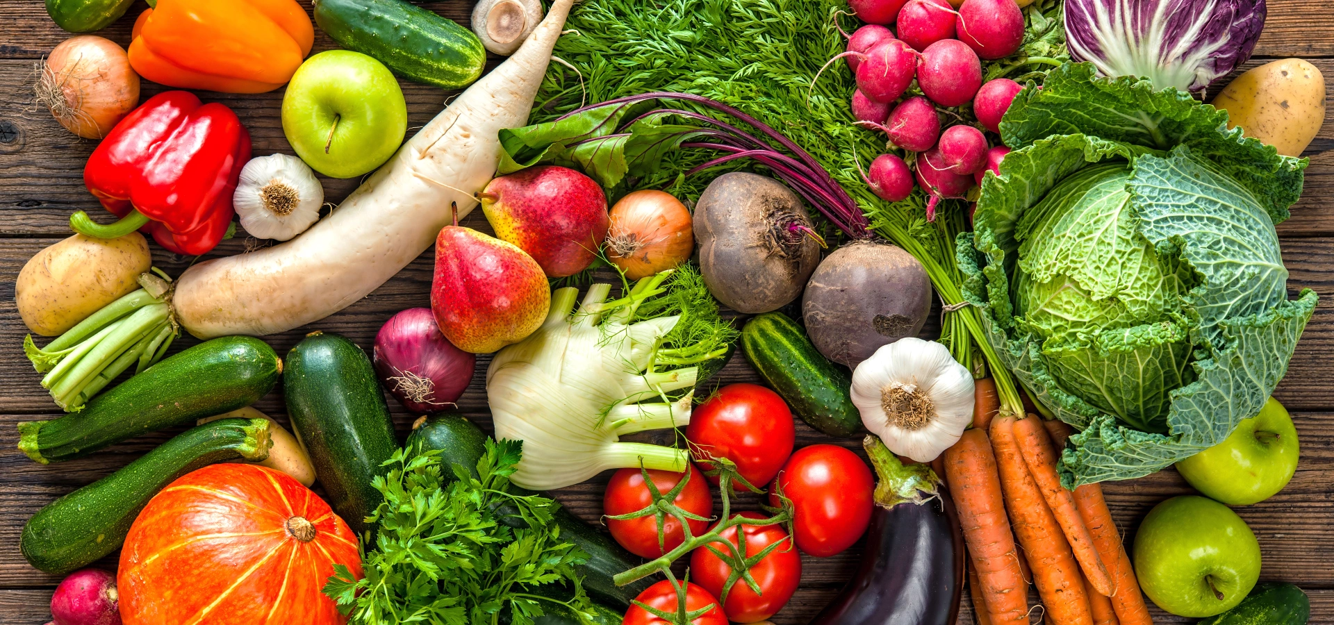 Spread of varied vegetables, including tomatoes, salads, aubergines, courgettes, etc.