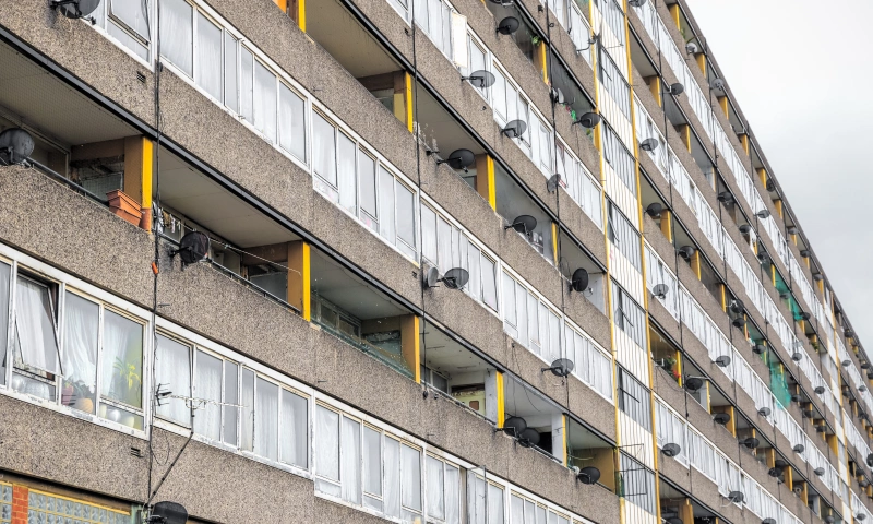 Tower block balconies with satellite dishes.