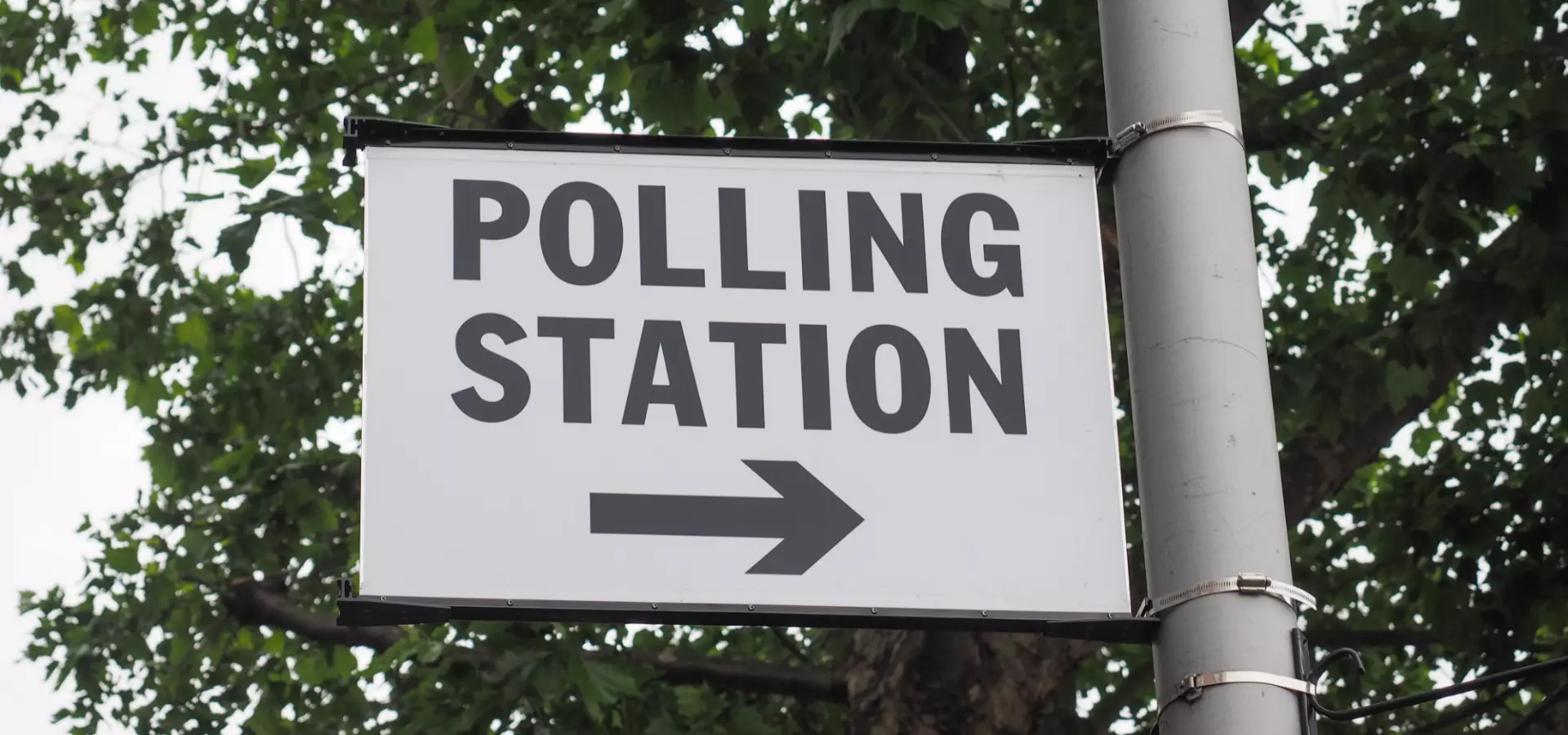 A sign attached the a lamp-post with the words 'Polling station'.