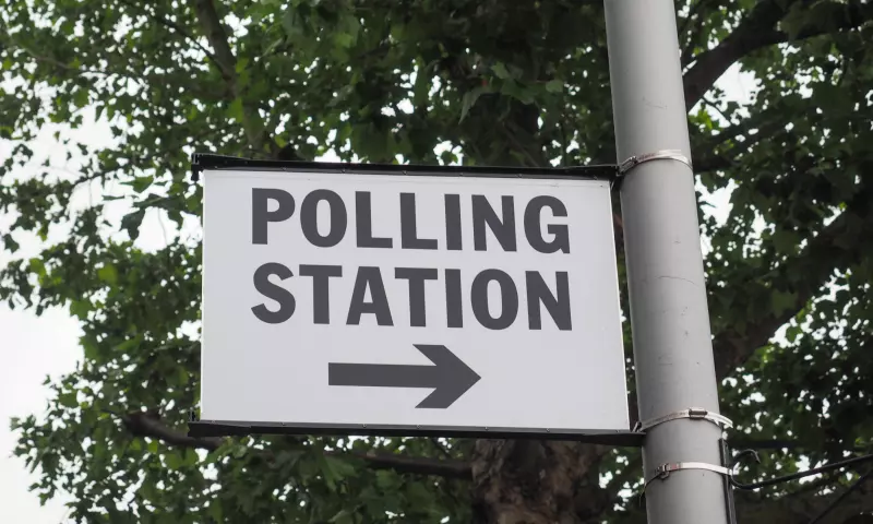 A sign attached the a lamp-post with the words 'Polling station'.