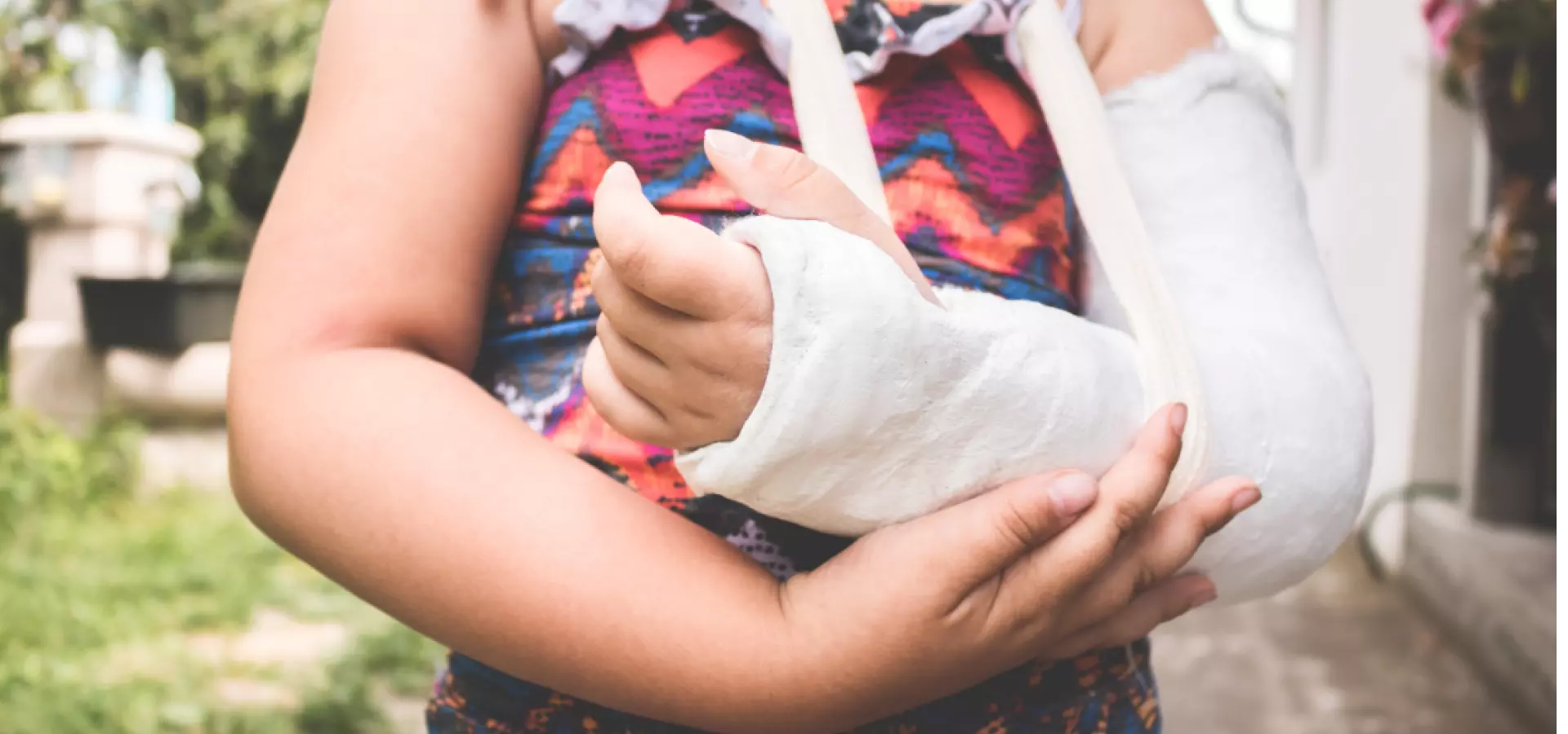 Young girl with a broken arm in a cast.