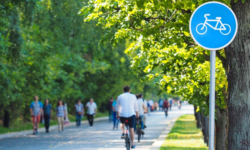 Cyclists and pedestrians in a park.