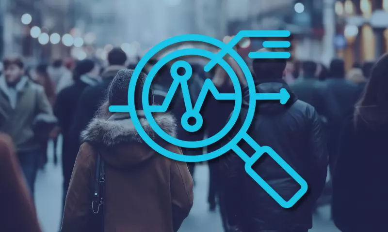 Background: crowd walking in a street. Foreground: icon symbolising 'overview', including a magnifying glass and some graphs.