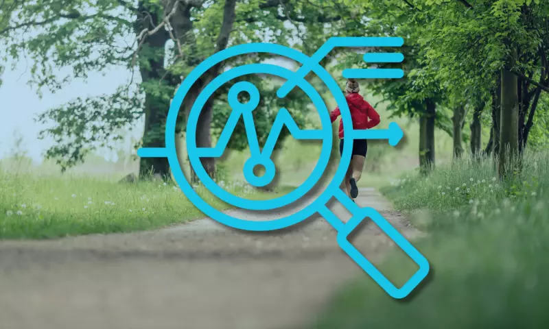 Person running in the woods, with an icon of a magnifying glass on top of the image.