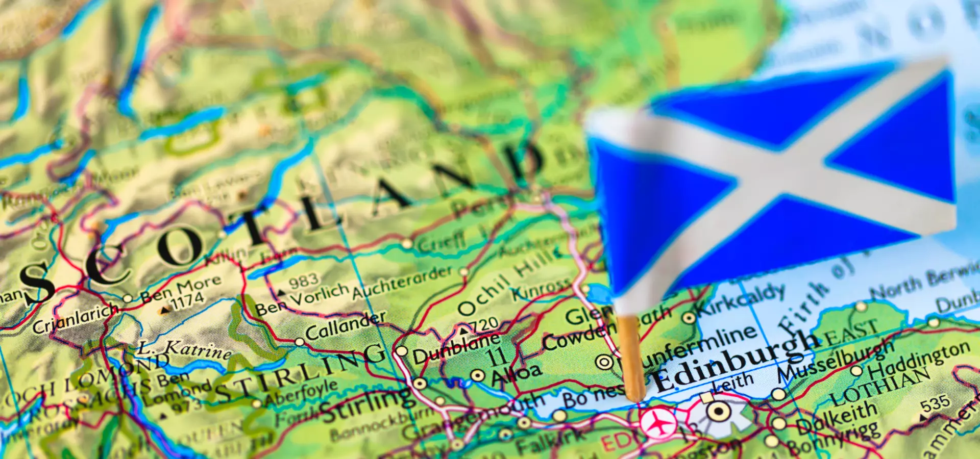 Partial map of Scotland with a the Scottish flag pinned on it.