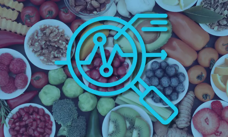 Selection of colourful fruit and vegetables photographed from above, with a magnifying glass icon on top signifying 'overview'.